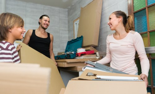 Professional movers unloading boxes at a new Catford address