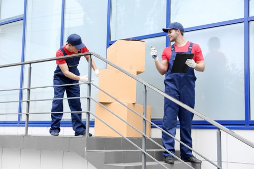 Professional house movers working in a Catford residential street