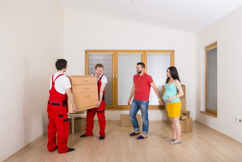 Packed office boxes and furniture ready for relocation in Catford